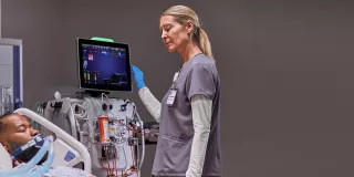 Doctor checking patient information on screen in hospital