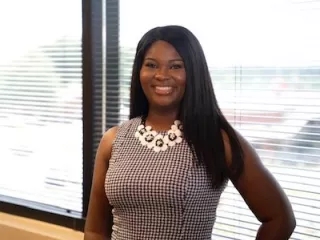 Woman smiling at the camera in an office environment
